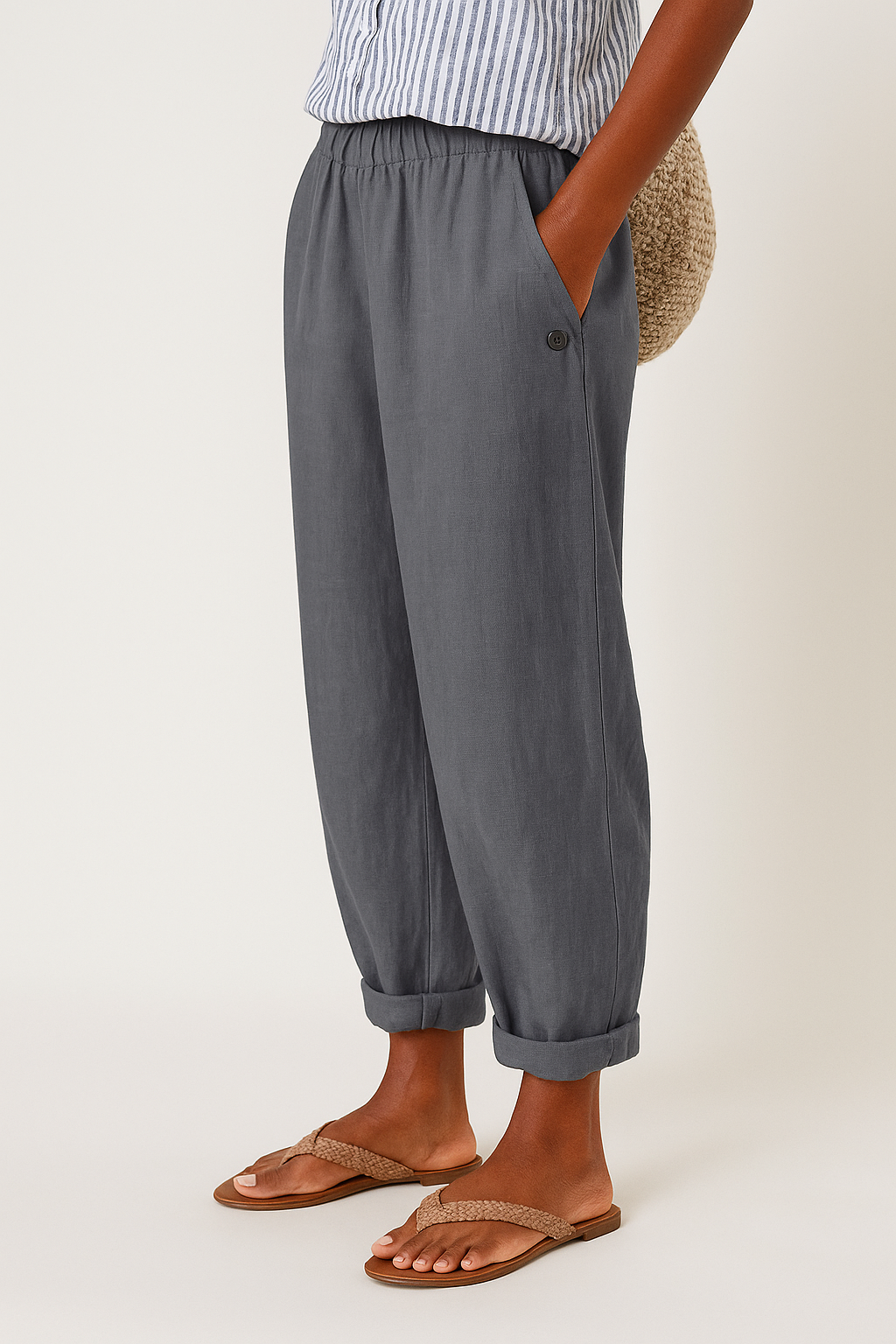 Female model wearing flattering high-waist pants with side pockets.