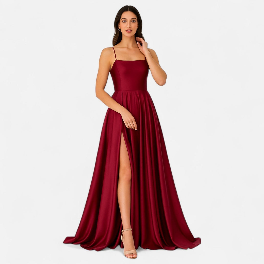 Female model front view in formal maxi dress, plain white background.