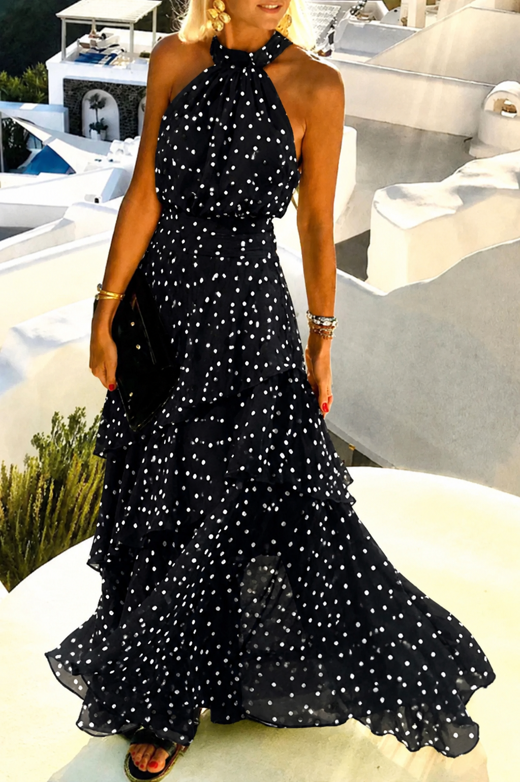 Woman posing in a sleeveless printed maxi dress with soft pleated details
