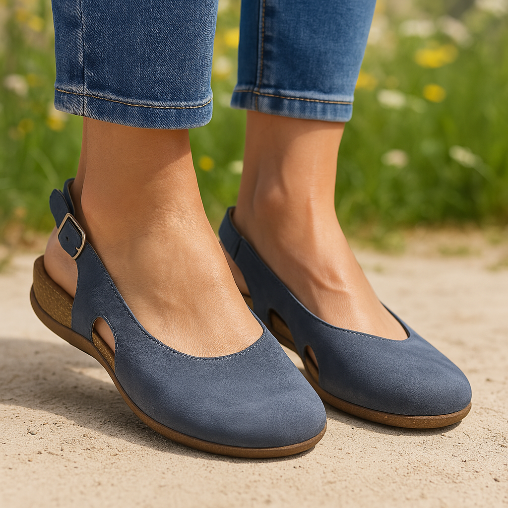 Woman wearing open toe sandals with adjustable back strap on a plain background.