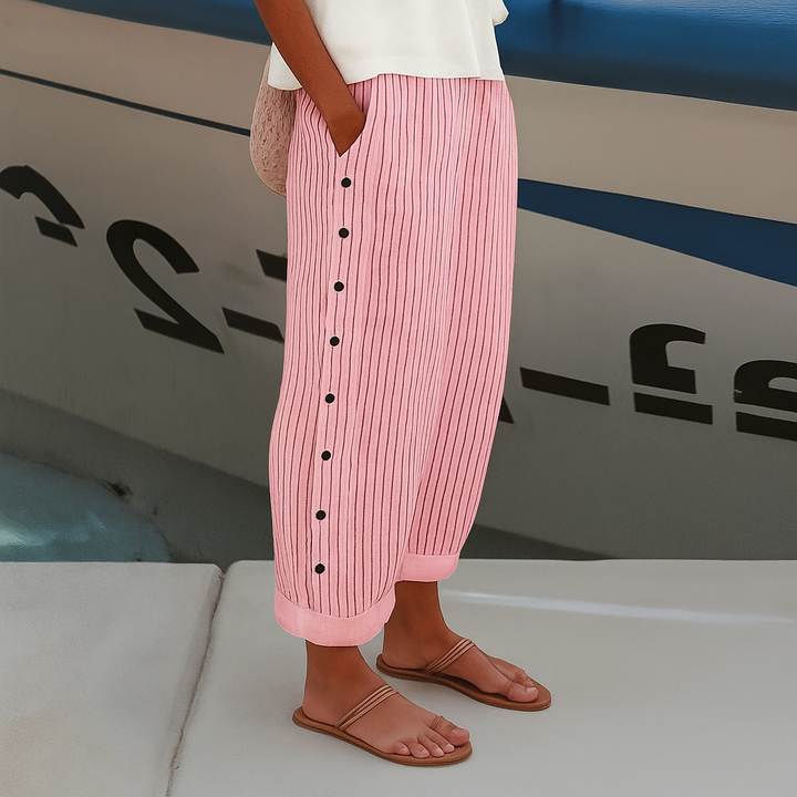 Woman in breathable casual trousers with side pockets standing on a clean background.