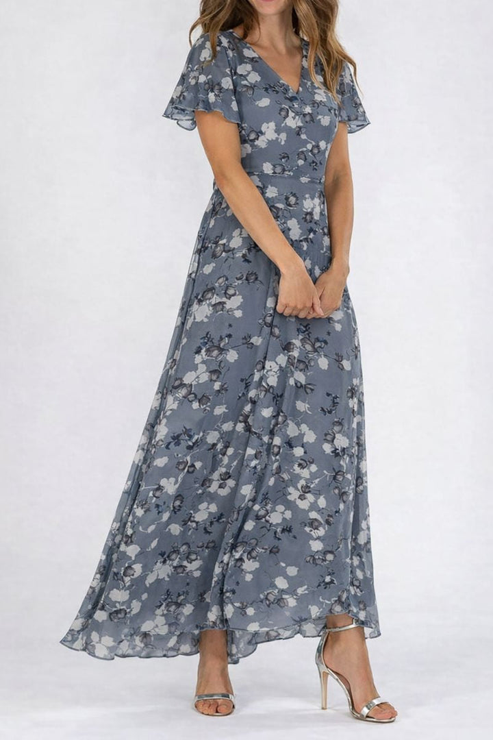 Female model showcasing an elegant long dress with soft draping on a clean background.