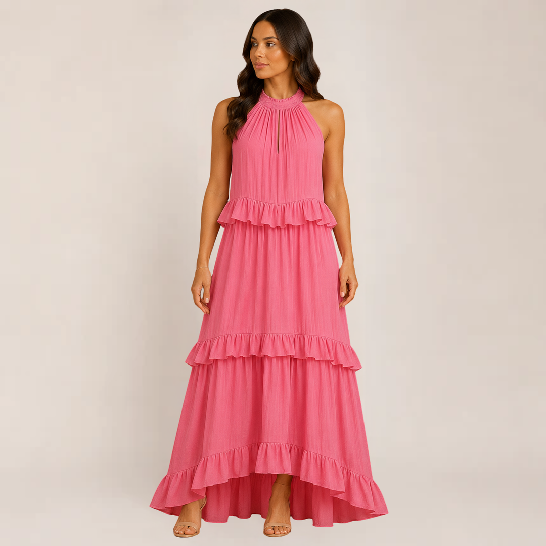 Female model wearing a lightweight tiered dress with delicate straps on a plain background.