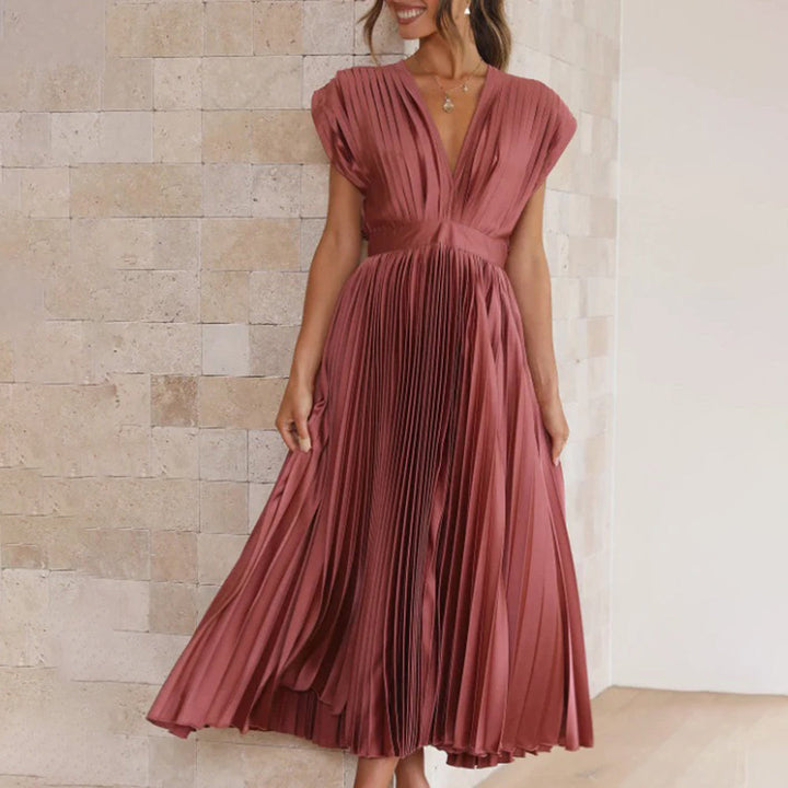Female model showcasing a refined dress on a clean background.
