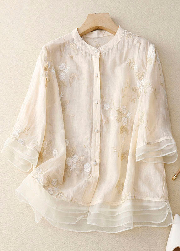 Lightweight feminine blouse with delicate embroidery on a plain background.