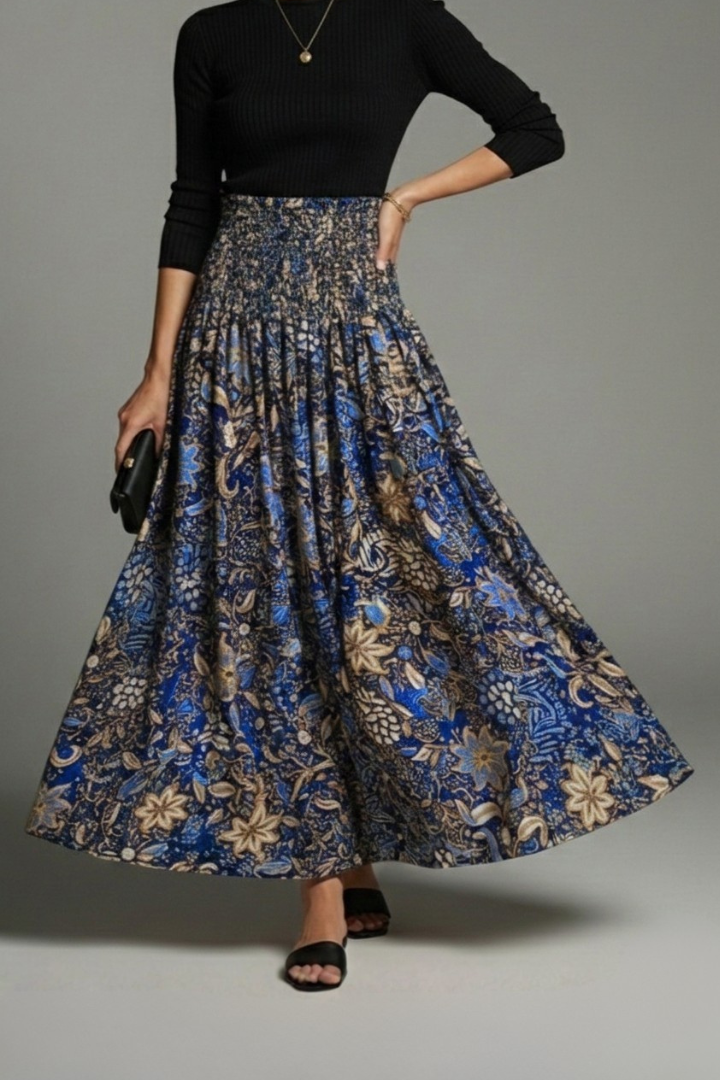 Model wearing a flared long skirt front display in grey plain background