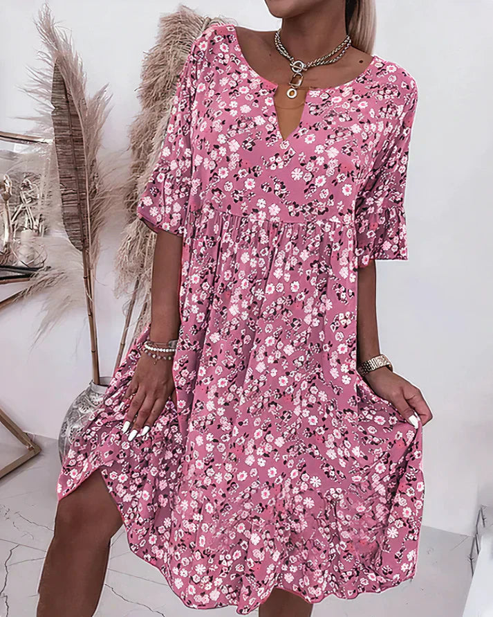 Female model wearing a relaxed shift dress against a plain background.