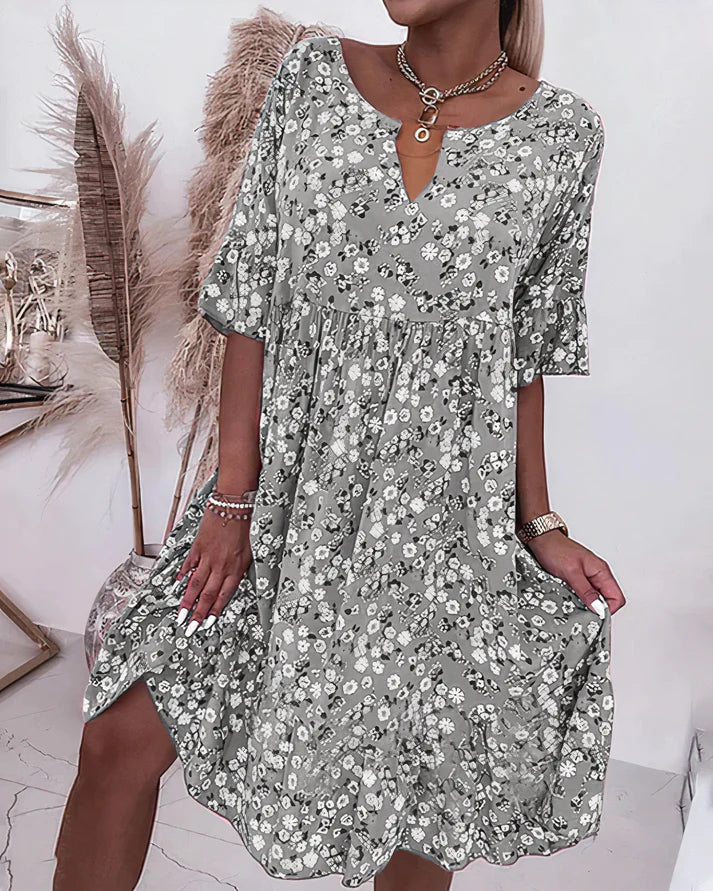 Female model showcasing a casual lightweight shift dress in a studio setting.