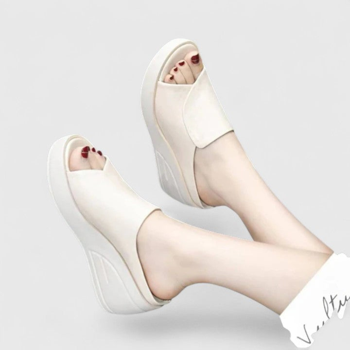 Lightweight orthopedic sandals on a plain background featuring supportive wedge soles