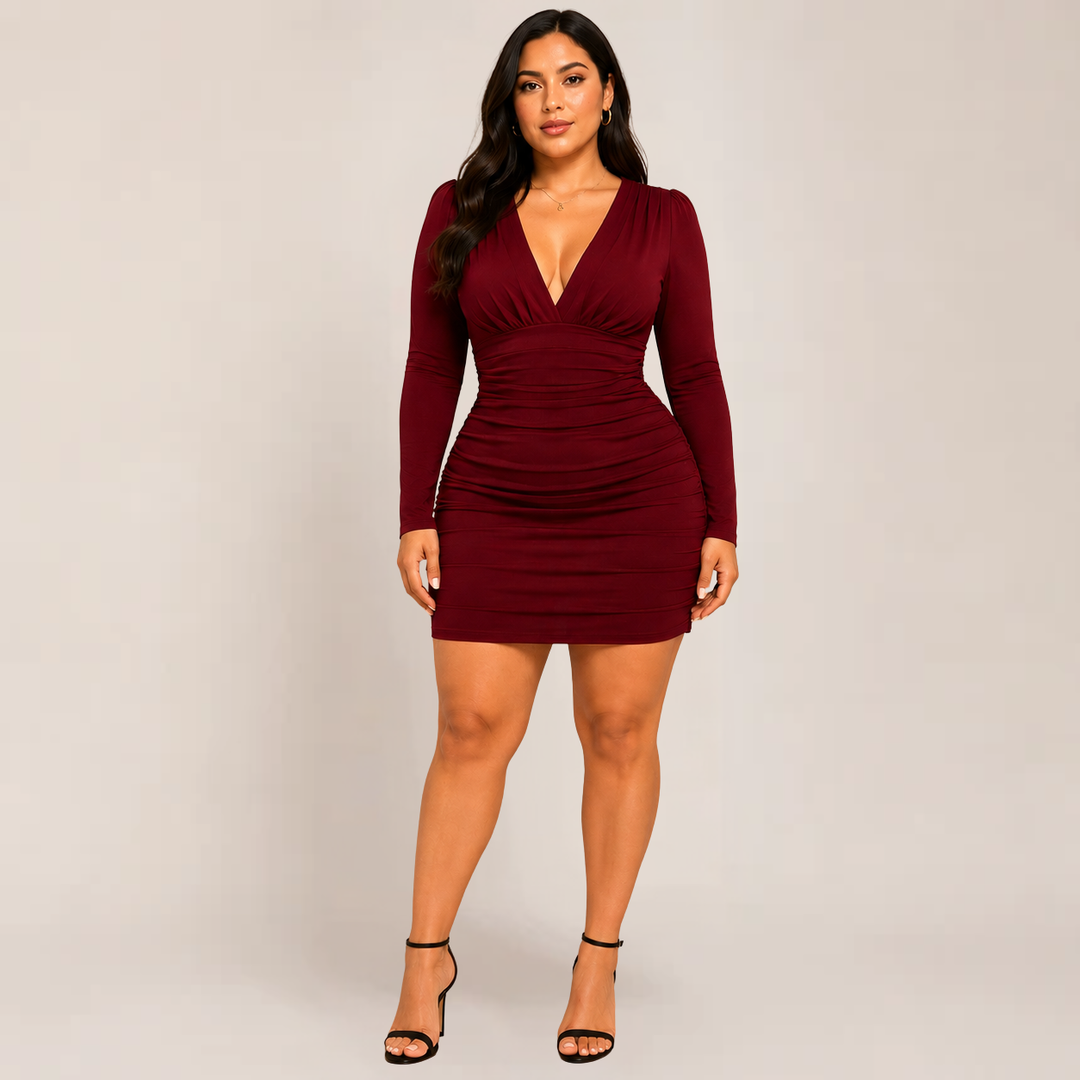 Female model showcasing a sleek bodycon mini dress with long sleeves on a plain background.