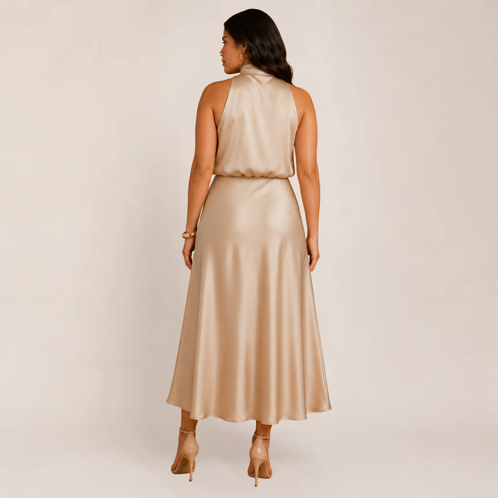 Model wearing an elegant halter dress with a refined neckline on a plain background.
