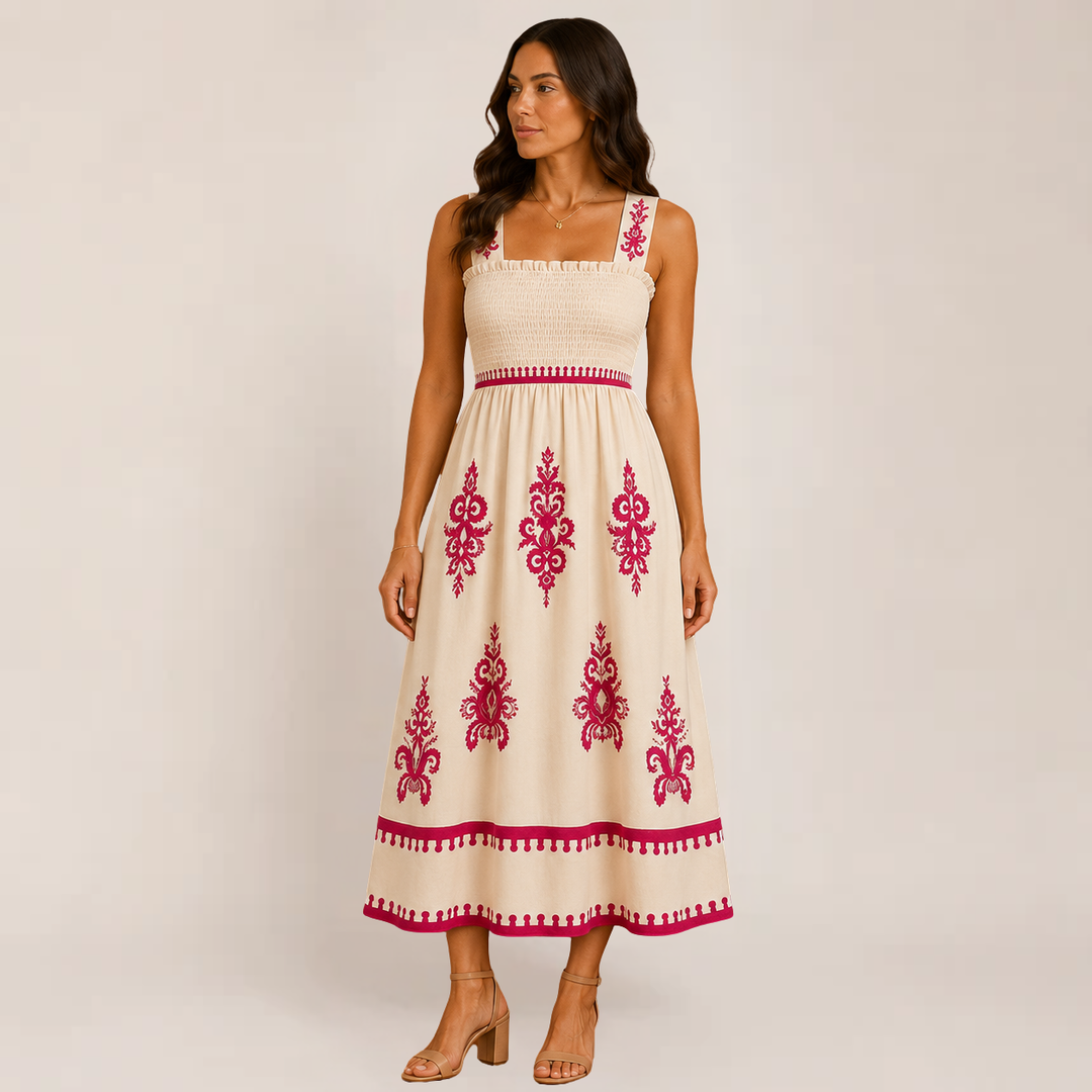 Female model in a flowy maxi dress with a relaxed warm-weather look on a plain background.