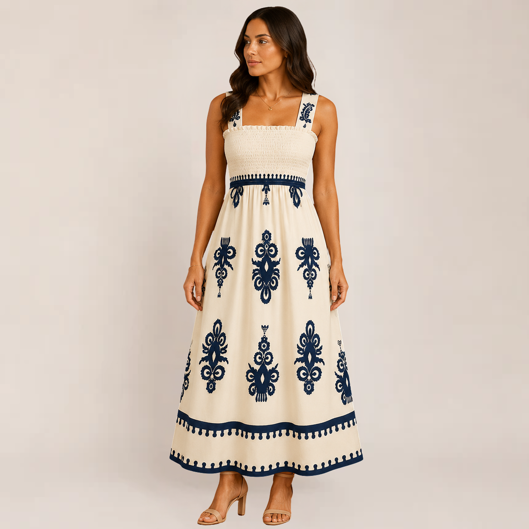 Female model showing a breezy maxi sundress with graceful movement on a plain background.