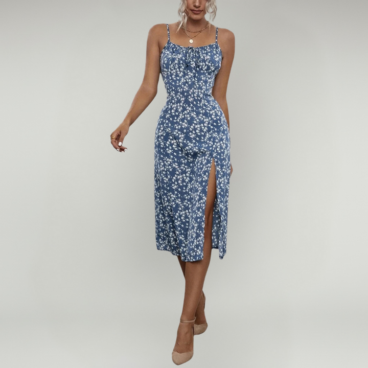 Model showcasing a floral midi dress with a front tie detail and side slit against a plain background.