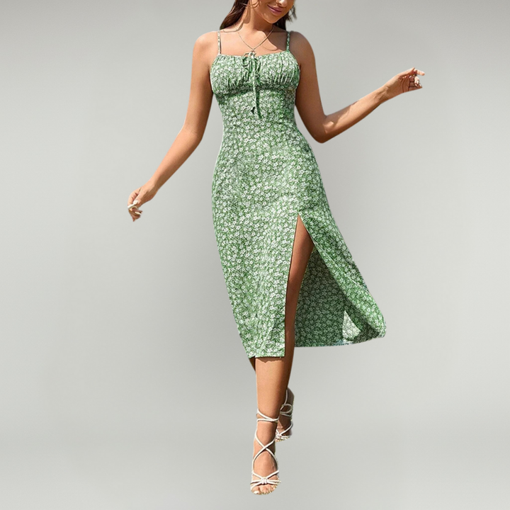 Woman wearing a floral print dress with delicate straps and a relaxed drape against a p
