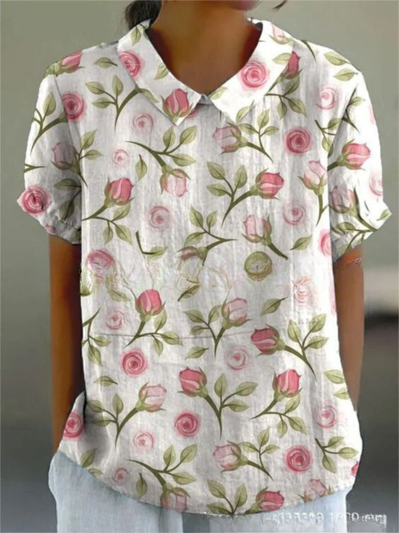 Feminine button-down floral top displayed on a clean background.