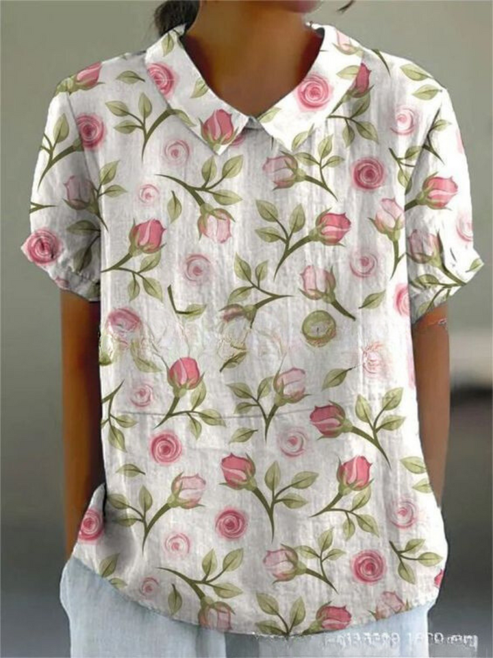 Feminine button-down floral top displayed on a clean background.