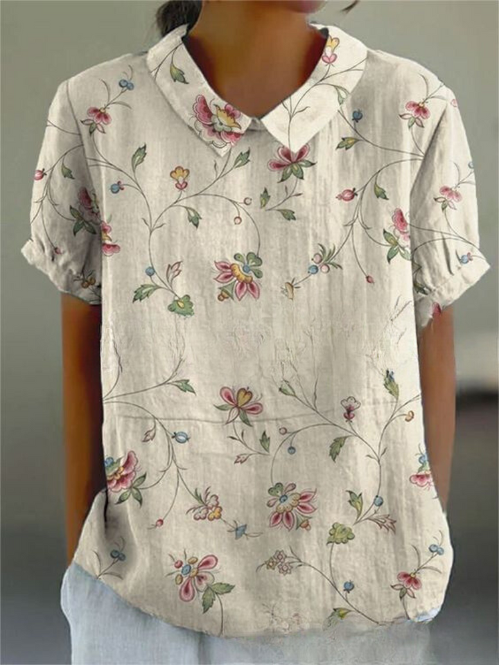 Relaxed-fit floral blouse worn for a polished everyday look.