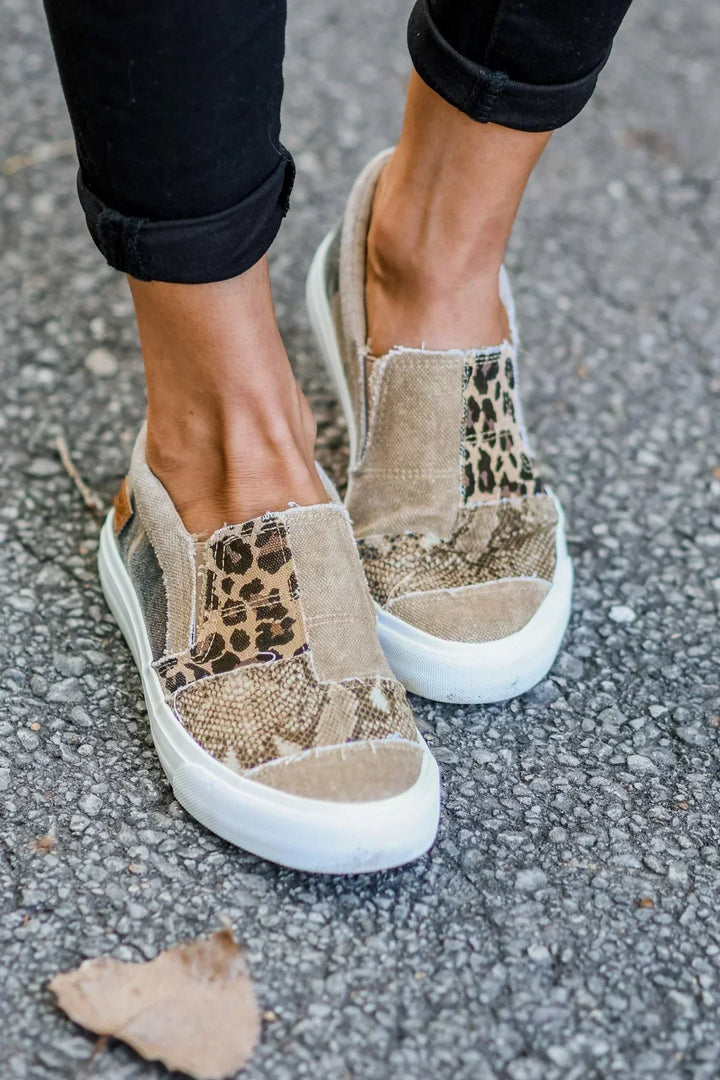 Female model showing feet wearing slip-on walking shoes on a plain background.