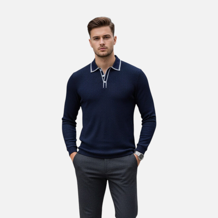 Male model wearing a navy long-sleeve button-down shirt with white contrast detailing against a plain background.