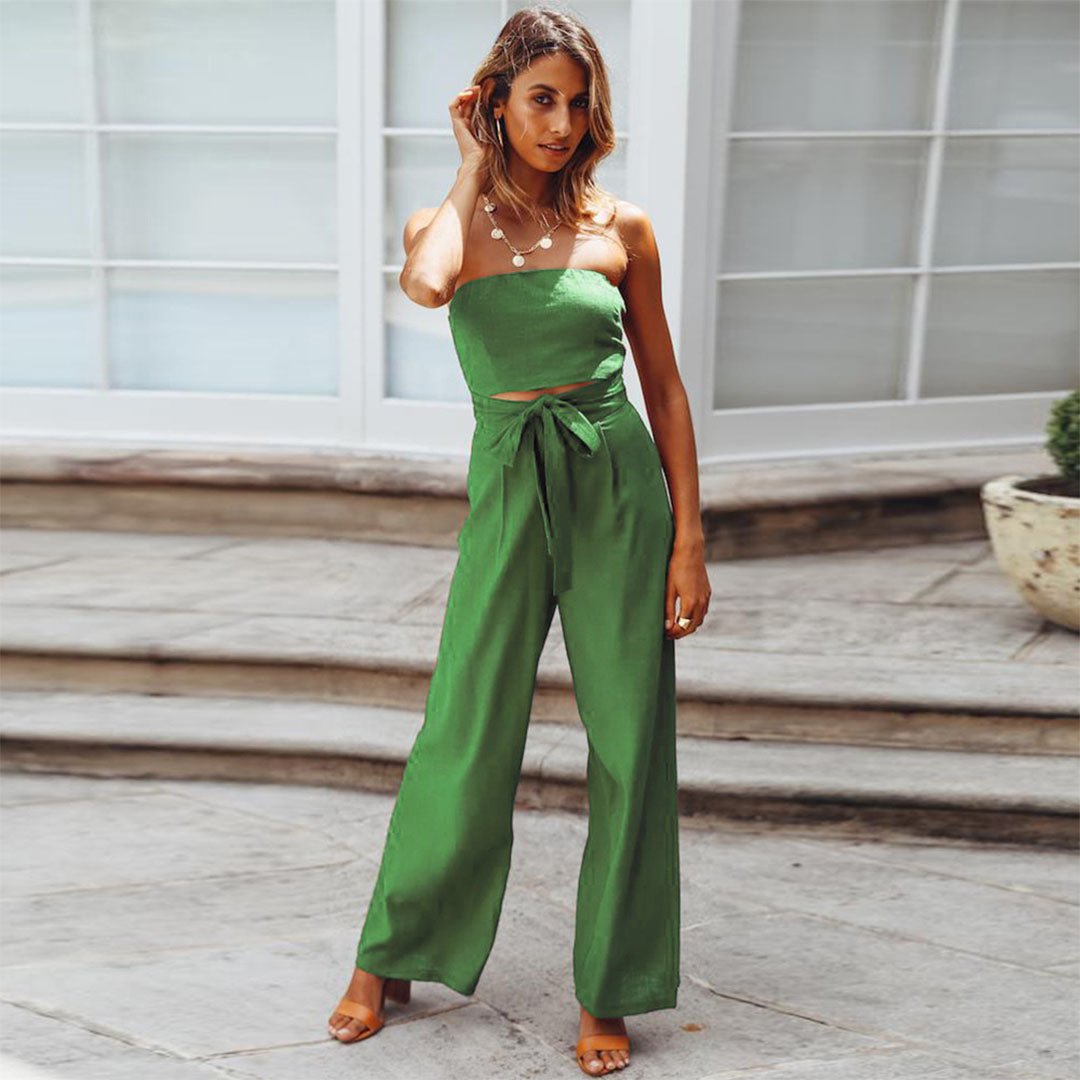 Female model showcasing a strapless one-piece outfit with wide-leg trousers.