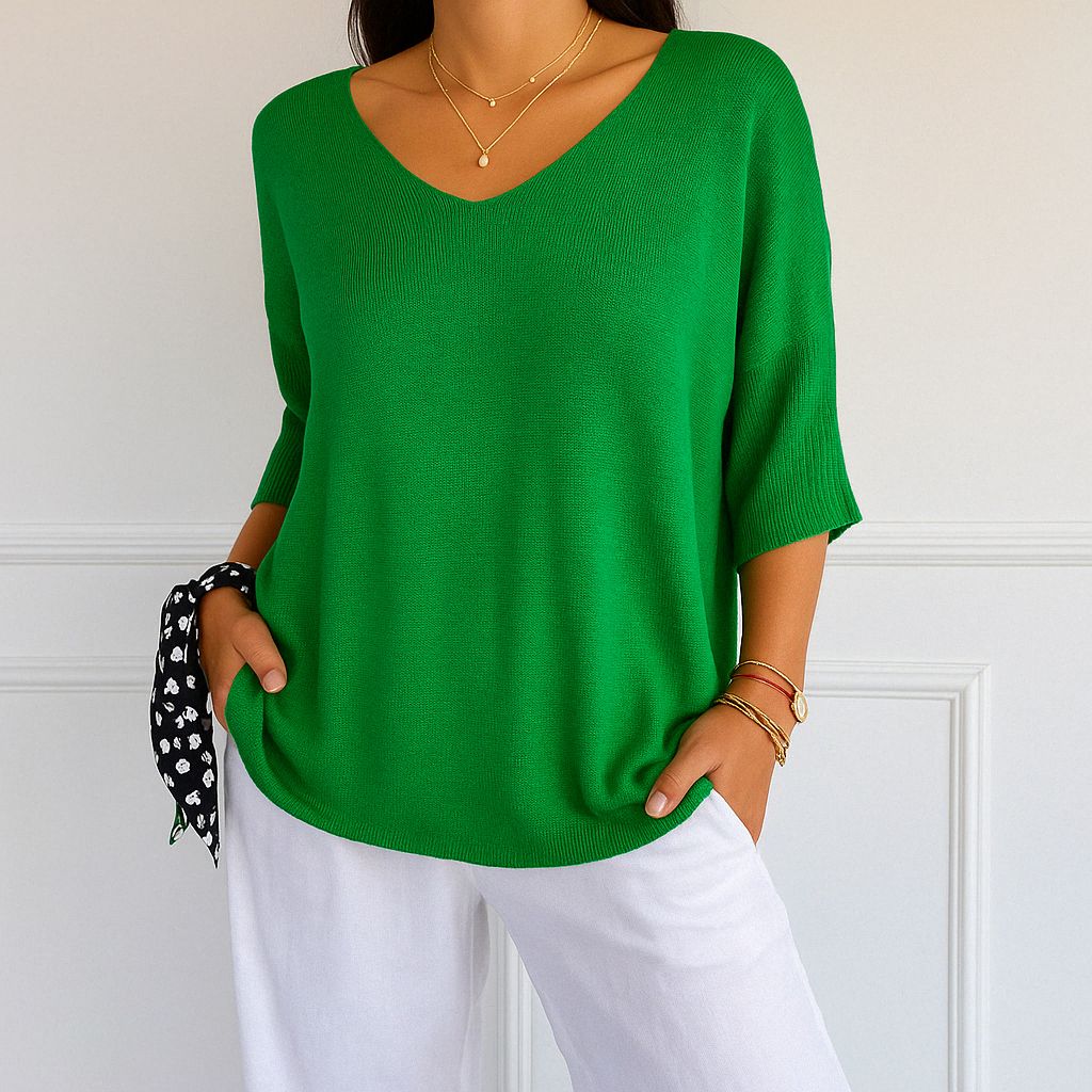 Tailored women’s top shown on plain background.