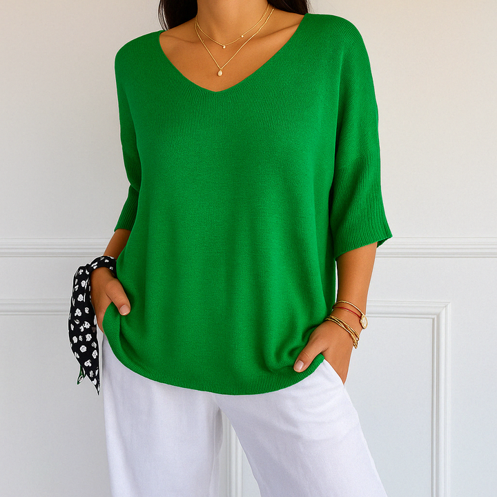 Tailored women’s top shown on plain background.