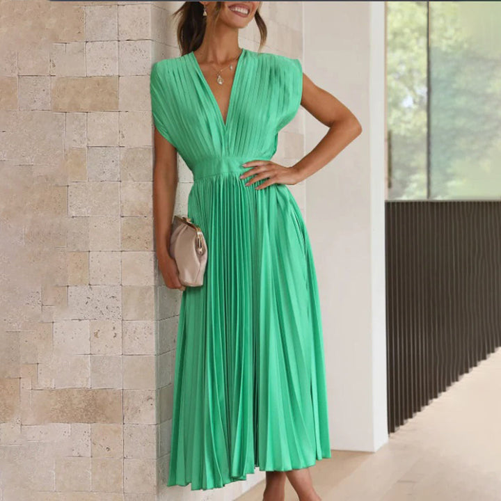 Model wearing a sophisticated dress with a clean background.