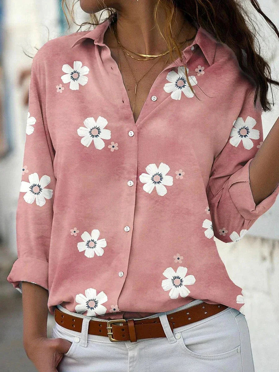 Floral blouse shown on a model against a clean background with a soft flowing silhouette.