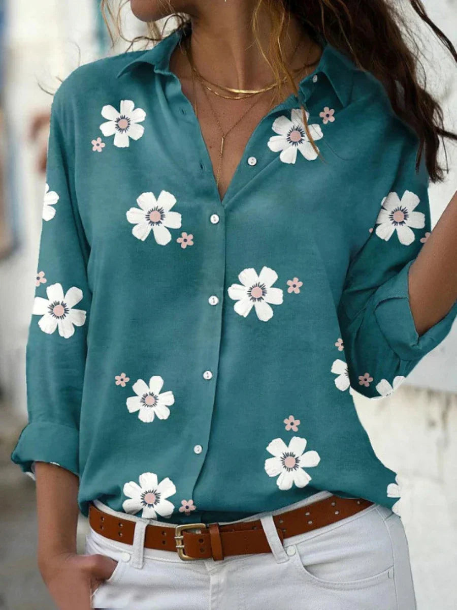 Flowing floral blouse presented on a model with a plain background and gentle drape.