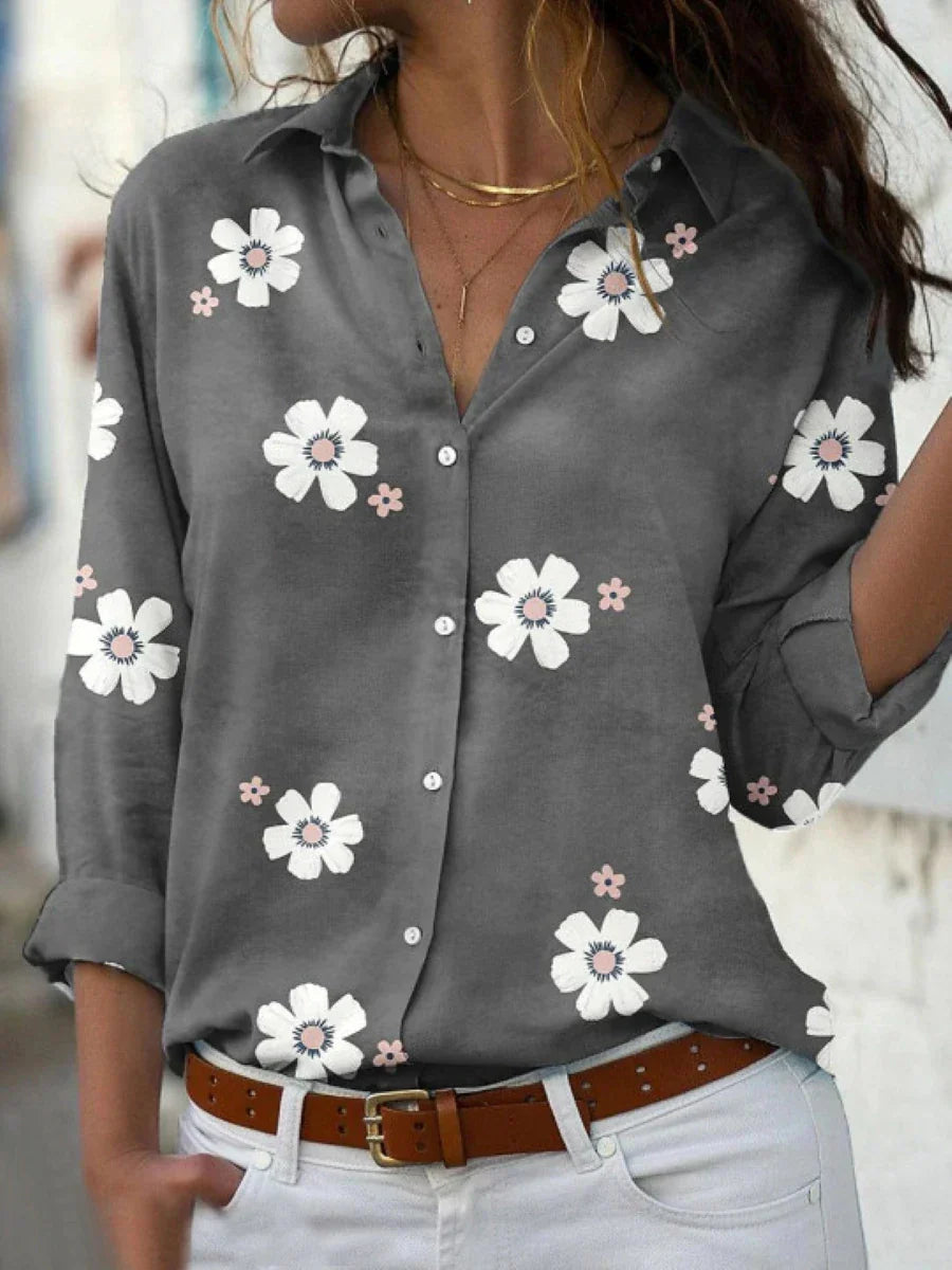 Lightweight floral top displayed on a model in a plain background highlighting relaxed elegance.