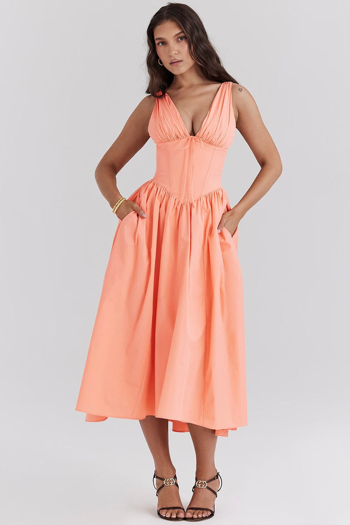 Model wearing a graceful flowy dress with a clean background.