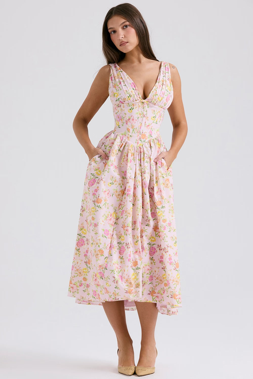 Female model in a light summer dress against a clean background.