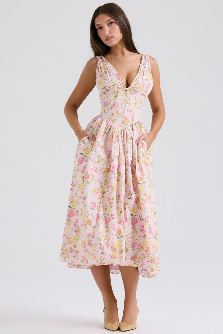 Female model in a light summer dress against a clean background.