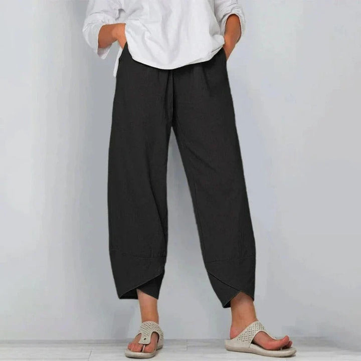 Woman modeling lightweight wide-leg summer pants on a clean background.