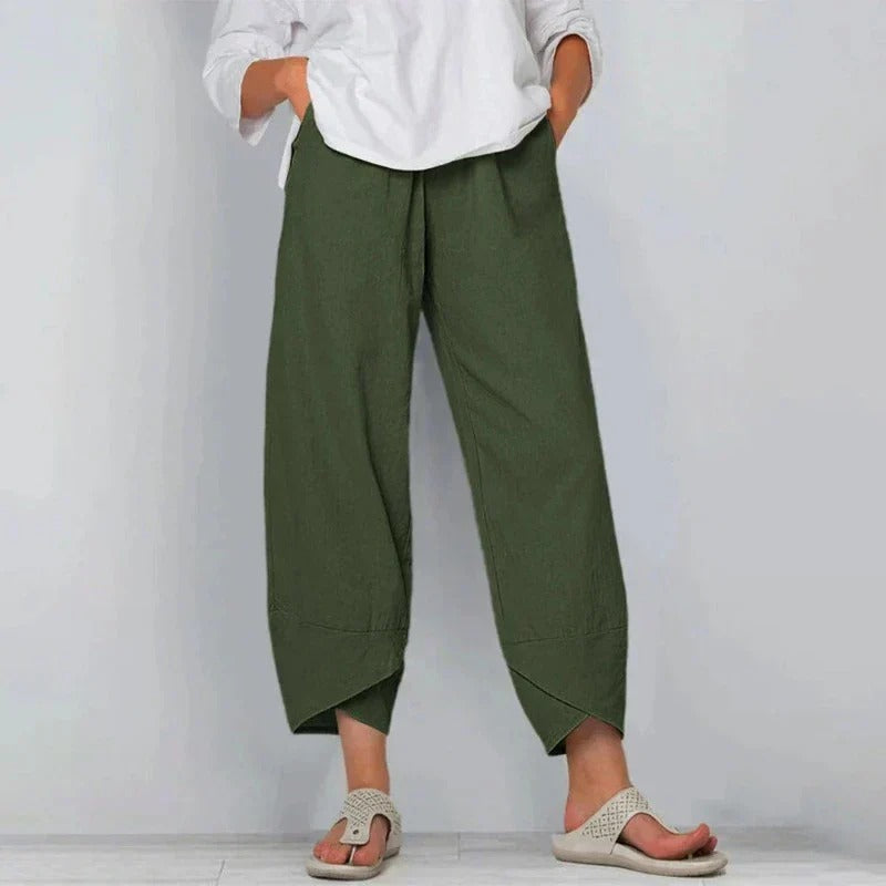 Model styling elegant wide-leg pants for warm-weather outfits on a clean background.