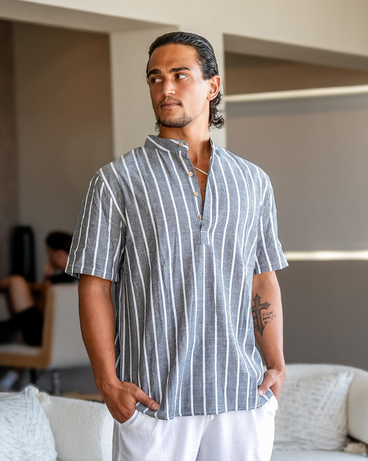  Male model displaying a striped casual polo paired with a relaxed neckline on a plain background.