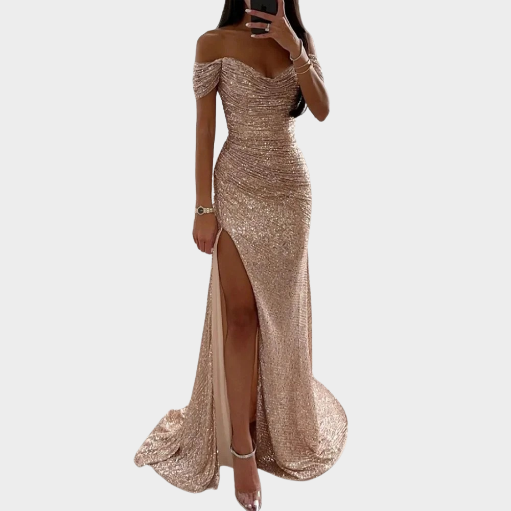 Woman wearing a dressy evening gown with soft sparkle and side pose on a plain background.