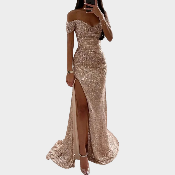 Woman wearing a dressy evening gown with soft sparkle and side pose on a plain background.