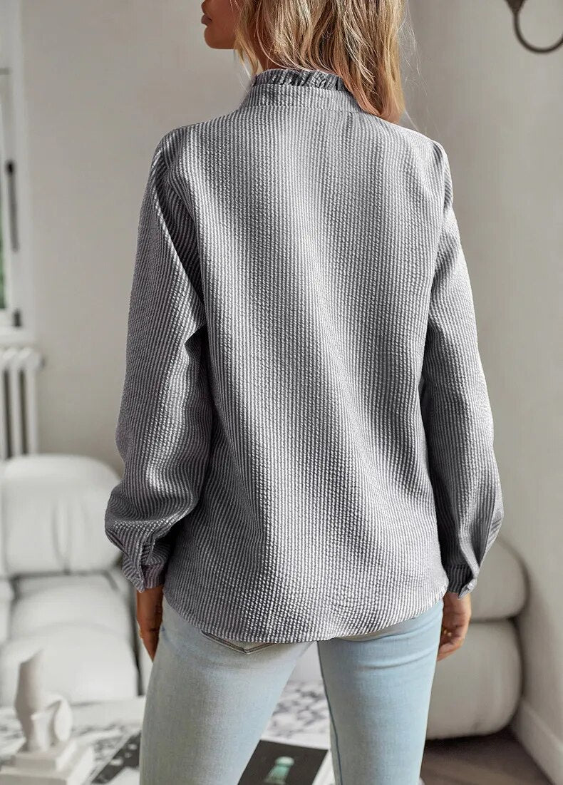 Comfortable relaxed top with smooth draping shown on a model against a clean background, back view