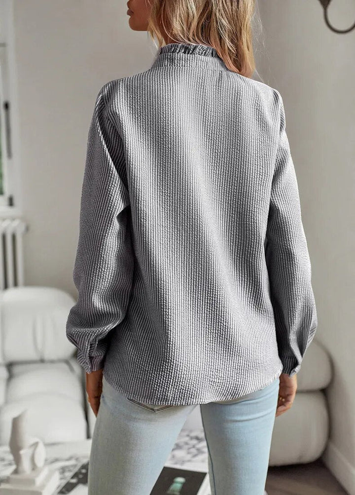 Comfortable relaxed top with smooth draping shown on a model against a clean background, back view