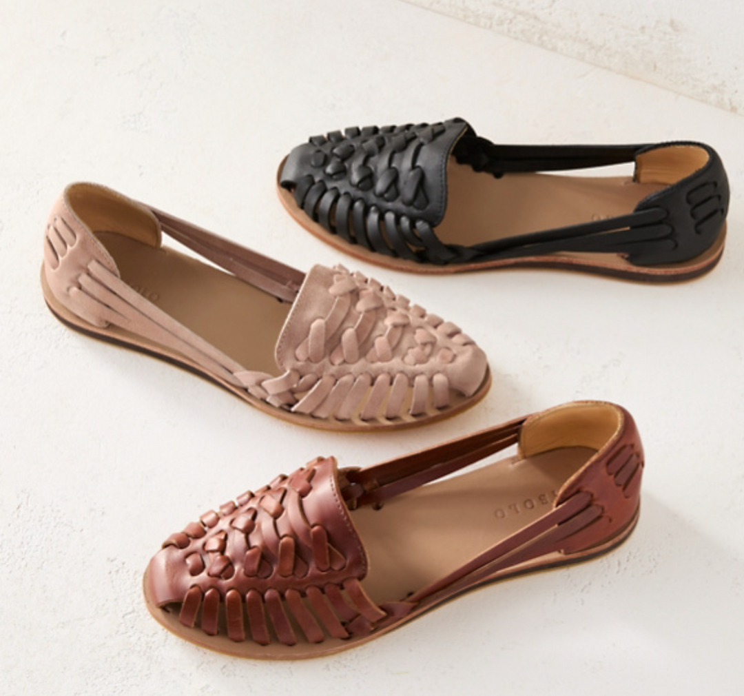 Closed toe ballet flats on a plain background.