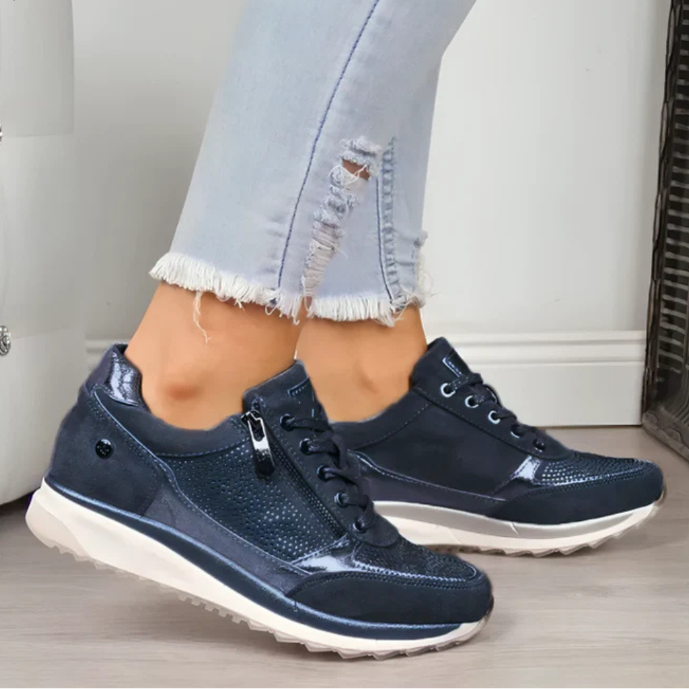 Woman standing in everyday slip-on shoes on a plain background.