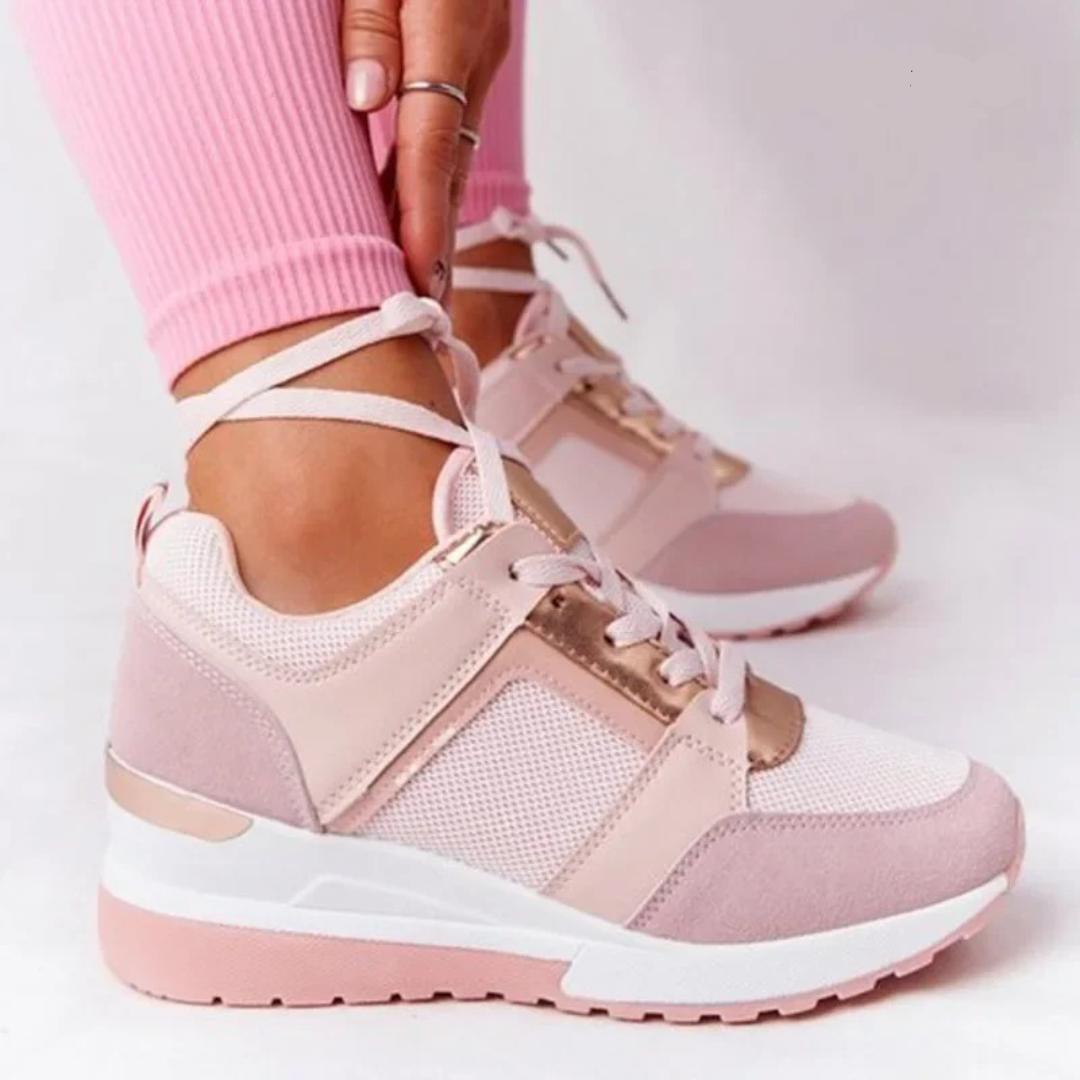 Female model showing everyday walking shoes on a plain background.