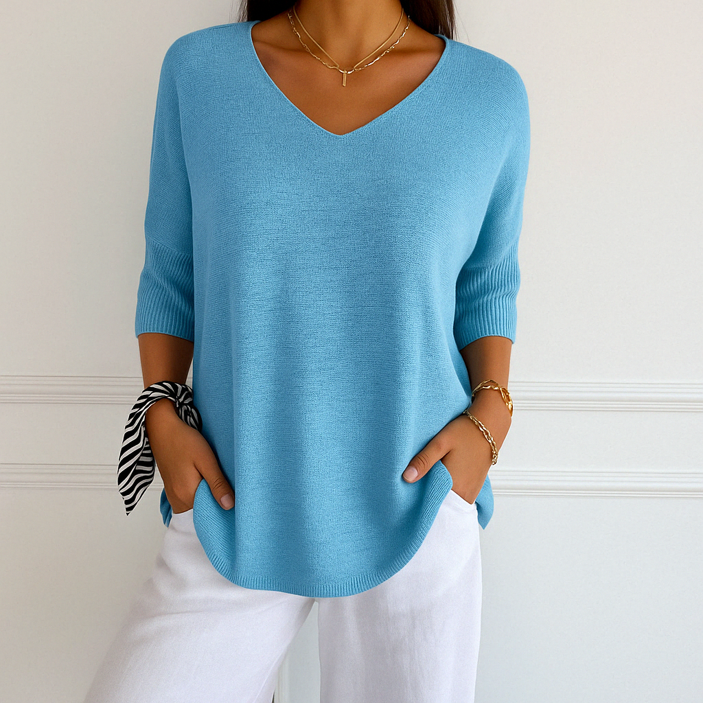 Long sleeve women’s knitwear displayed on plain background.