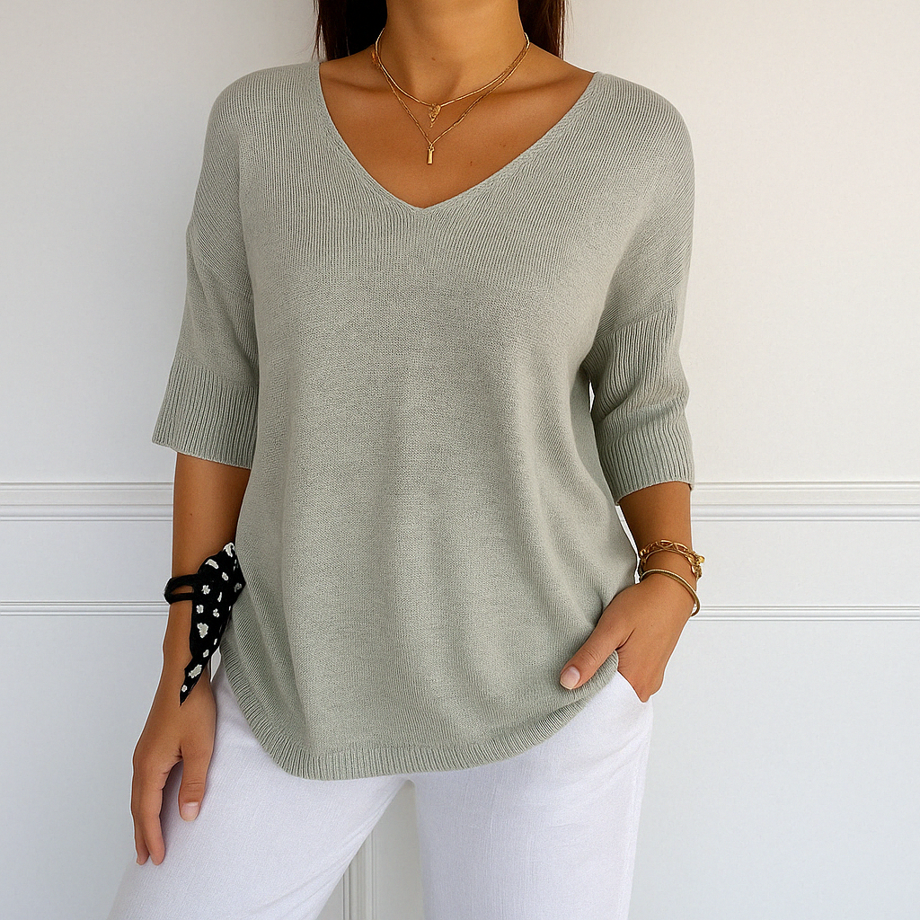 Long sleeve knit blouse front angle on plain background.