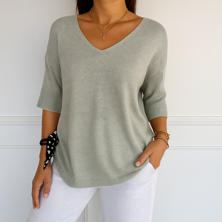 Long sleeve knit blouse front angle on plain background.