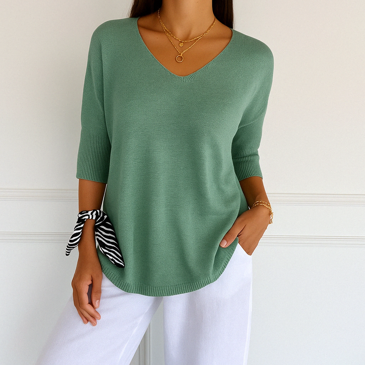 Elegant women’s blouse front ngle shown on plain background.