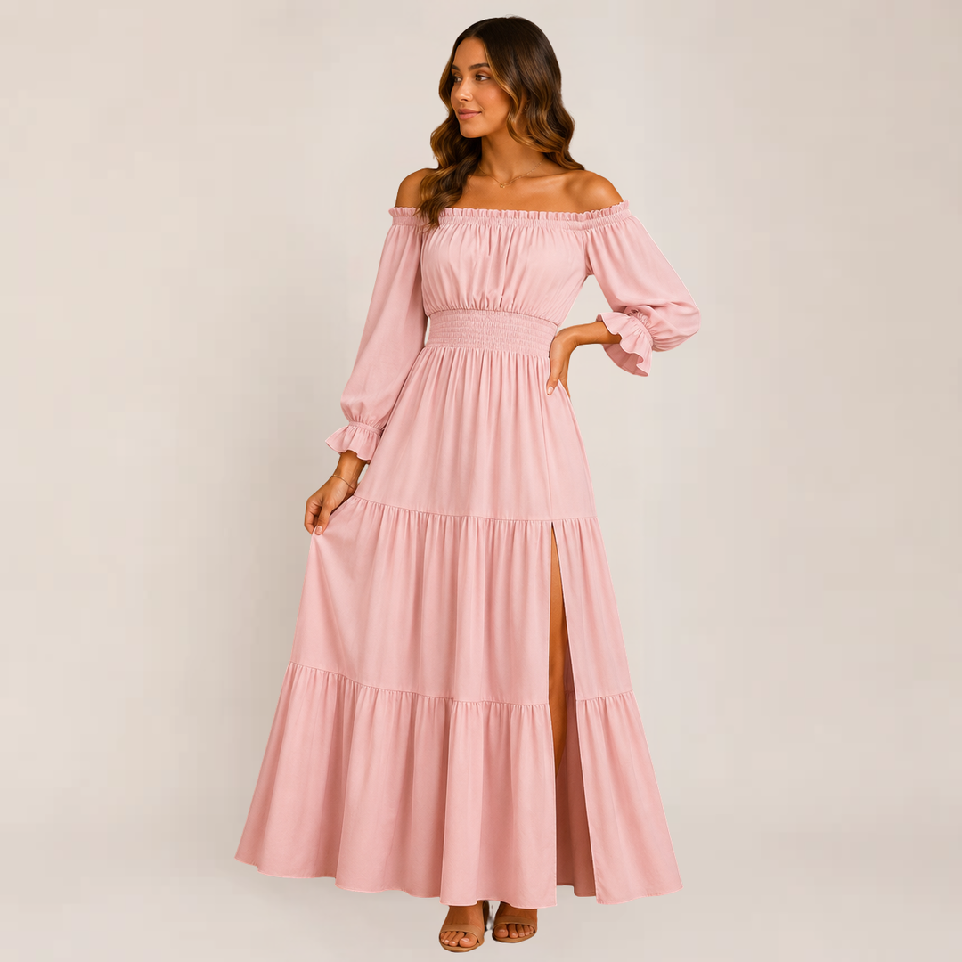 Female wearing an off-shoulder tiered dress on a plain background.