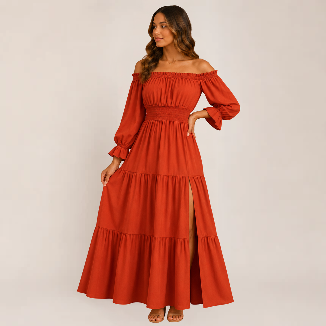 Woman styled in a soft flowing summer dress against a plain background.